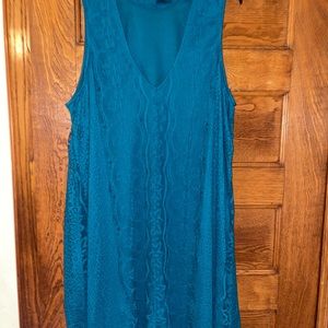 A beautiful teal dress that is below the knee. Has a pretty flower design.